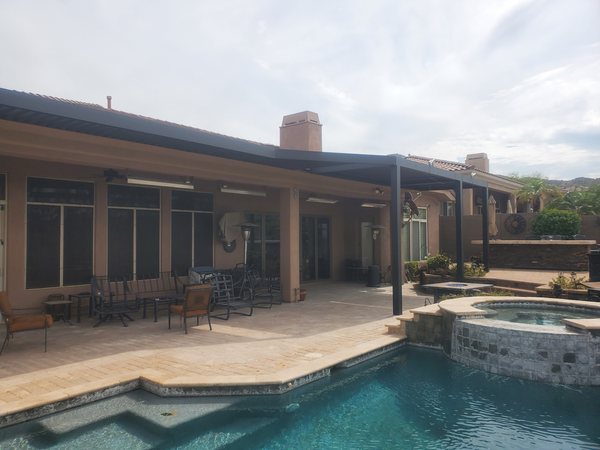 Attached aluminum patio cover along a backyard pool deck for Las Vegas area homes.