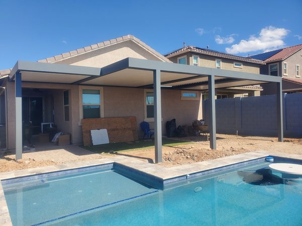 Light freestanding patio cover beside a pool for Southern Highlands area homes.