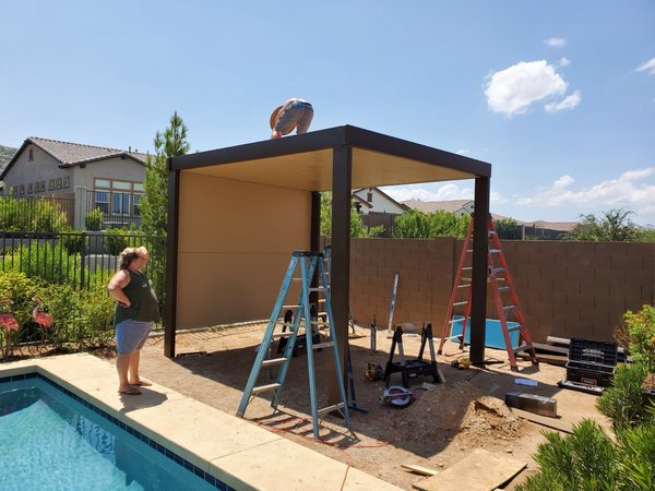 Tan aluminum patio cover installation for North Las Vegas area homes.