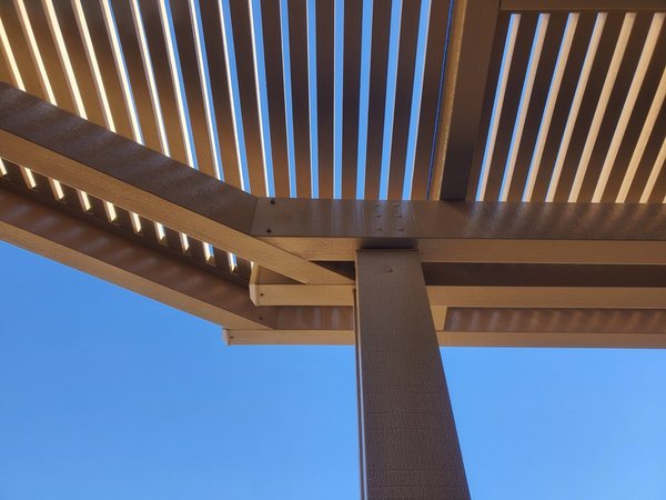 Close-up of tan aluminum lattice patio cover underside detail.