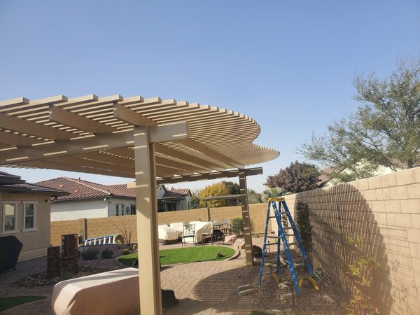 Tan lattice patio cover installation for North Las Vegas area homes.