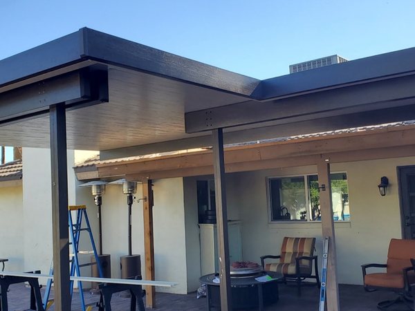 Attached patio shade cover with outdoor seating for Las Vegas area homes.
